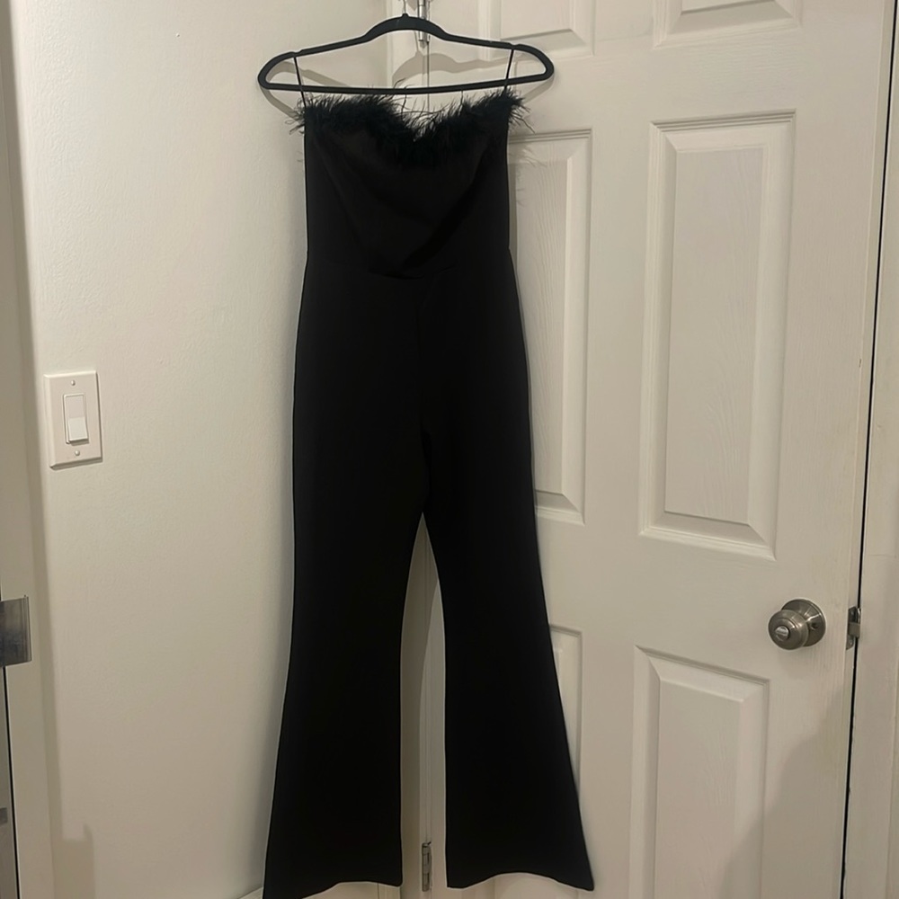 Black Flared Feathered Jumpsuit. Great condition only wore one time. Fits a S/M